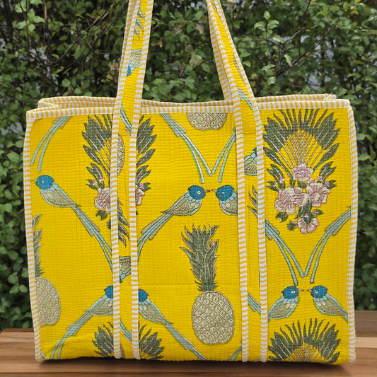 yellow and blue birds and fruits pattern quilted cotton tote bag reversible machine washable with pockets lifestyle image