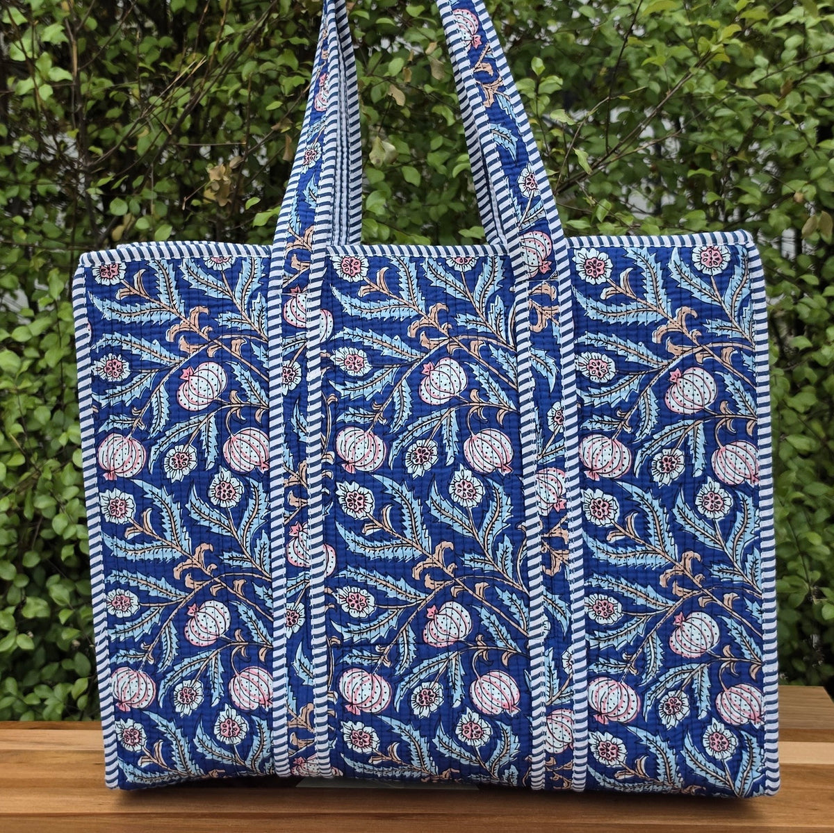 blooming blue pomegranates quilted cotton tote bag reversible machine washable with pockets lifestyle image