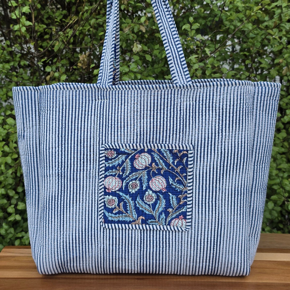 blooming blue pomegranates quilted cotton tote bag reversible machine washable with pockets lifestyle reverse image