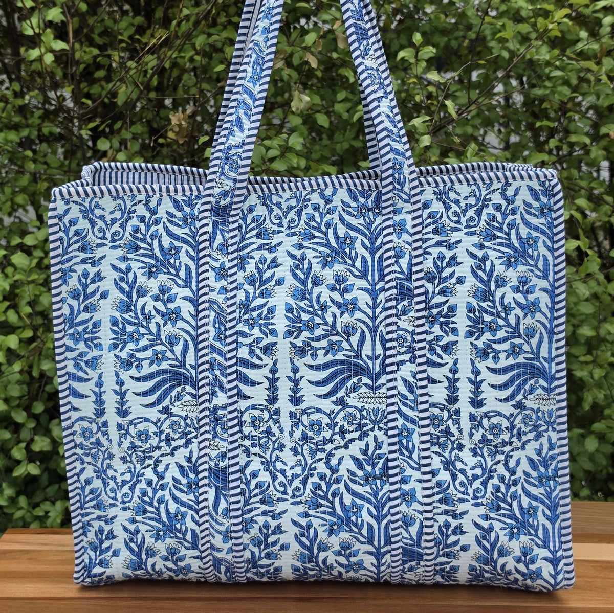 blue and white floral pattern quilted cotton tote bag reversible machine washable with pockets lifestyle image