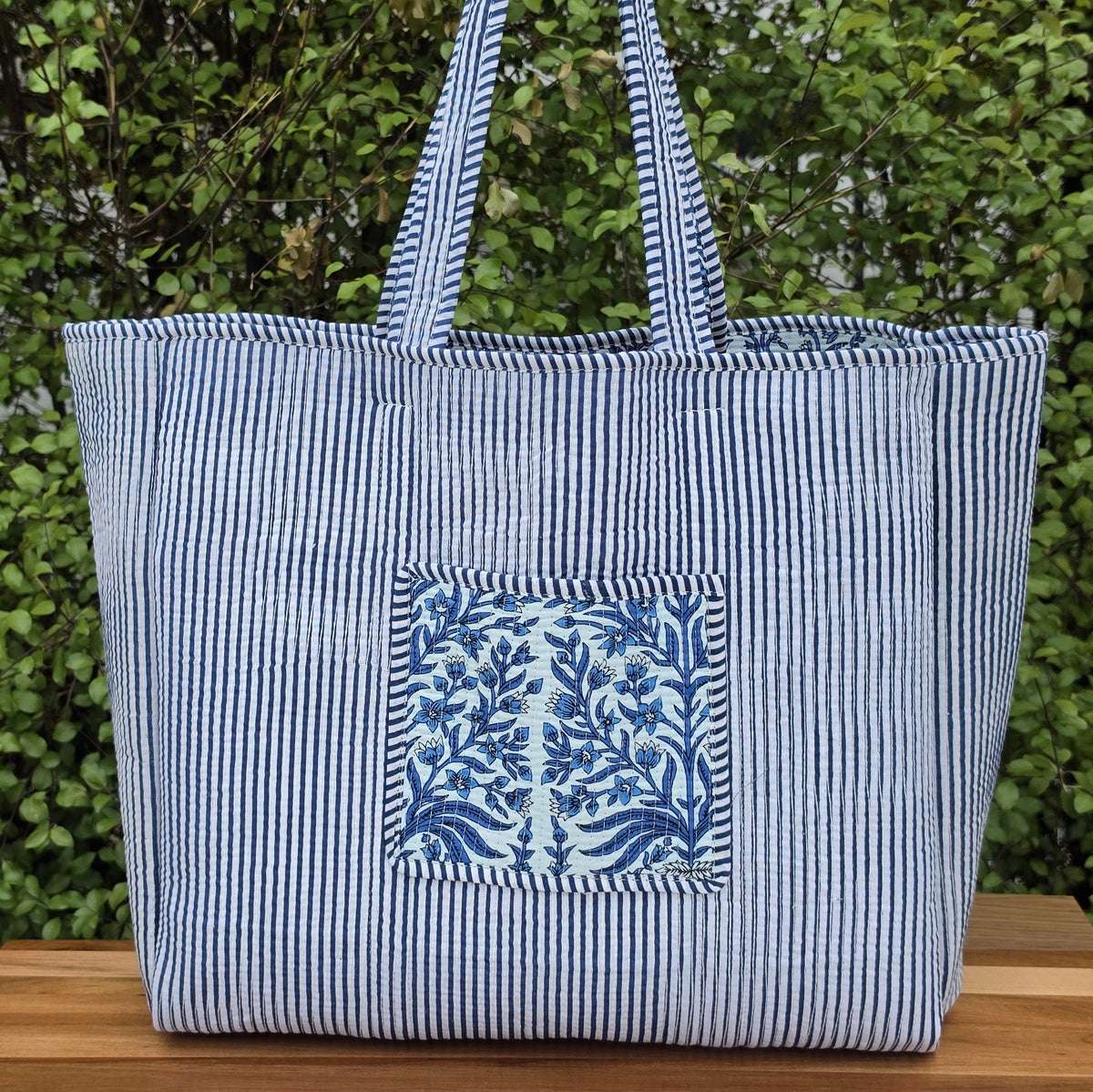 blue and white floral pattern quilted cotton tote bag reversible machine washable with pockets lifestyle reverse image