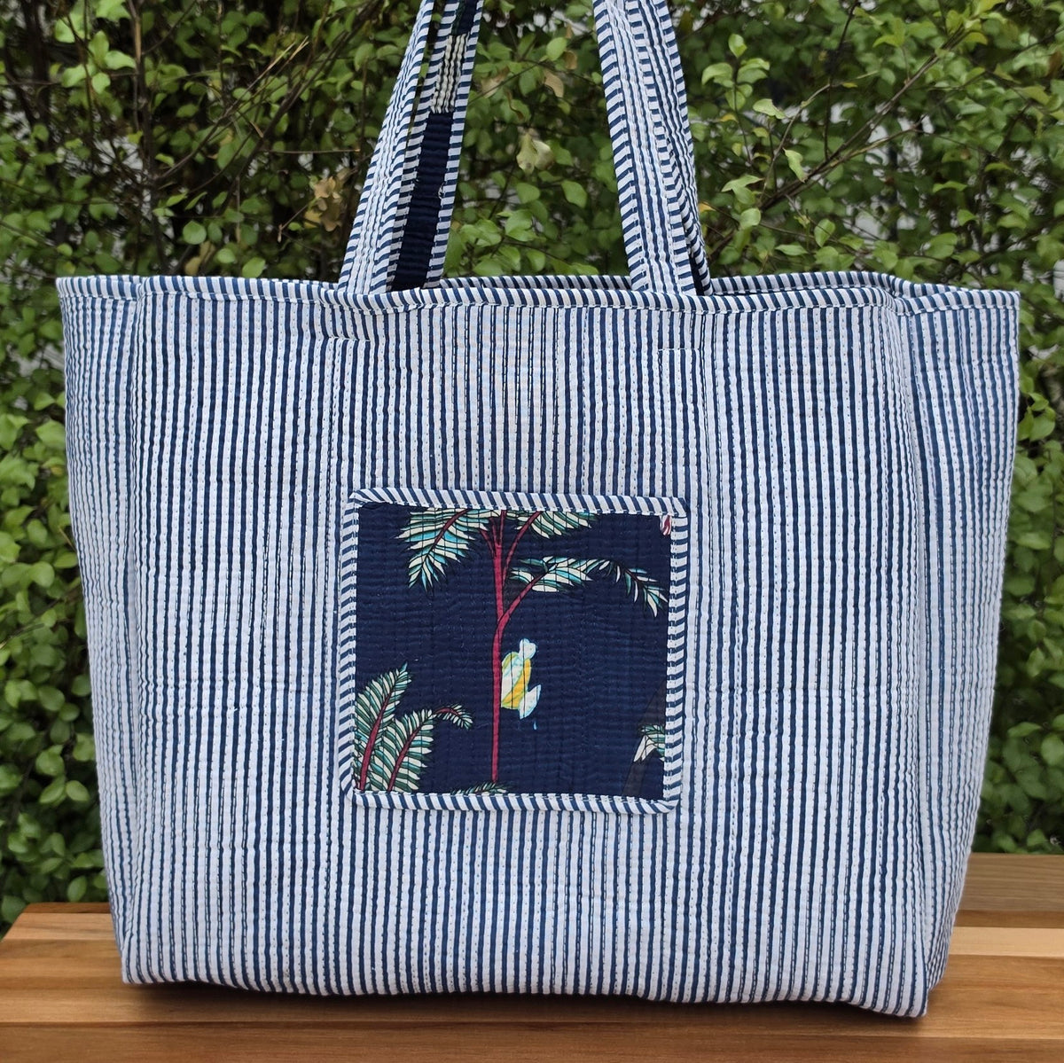 blue jungle print quilted cotton tote bag reversible machine washable with pockets reversible lifestyle shot