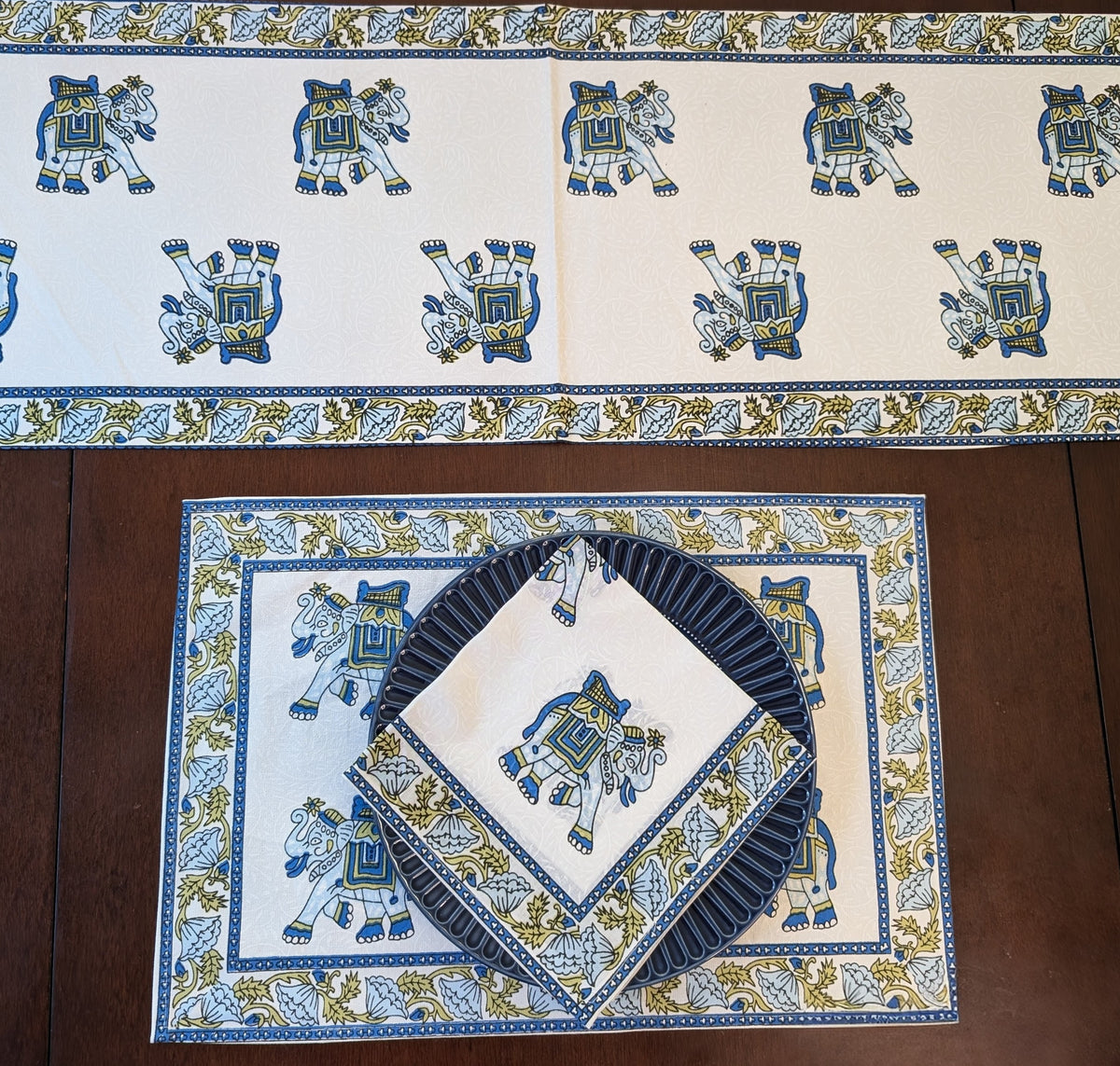 cotton table linen sets with placemats, napkins and runner on small elephant pattern on table