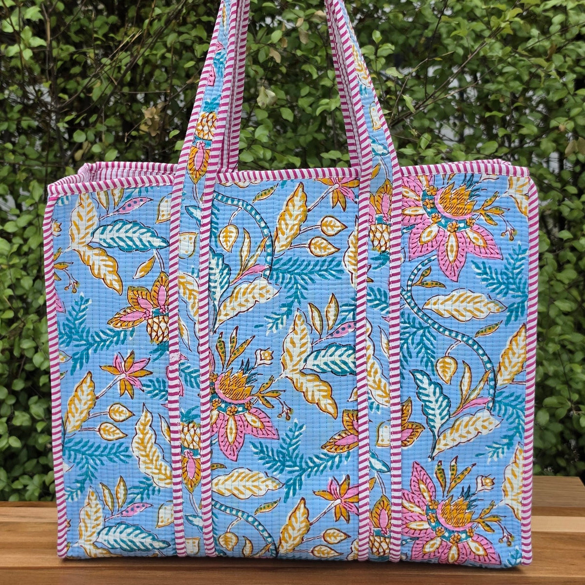 light blue floral and leaf pattern quilted cotton tote bag reversible machine washable with pockets lifestyle image