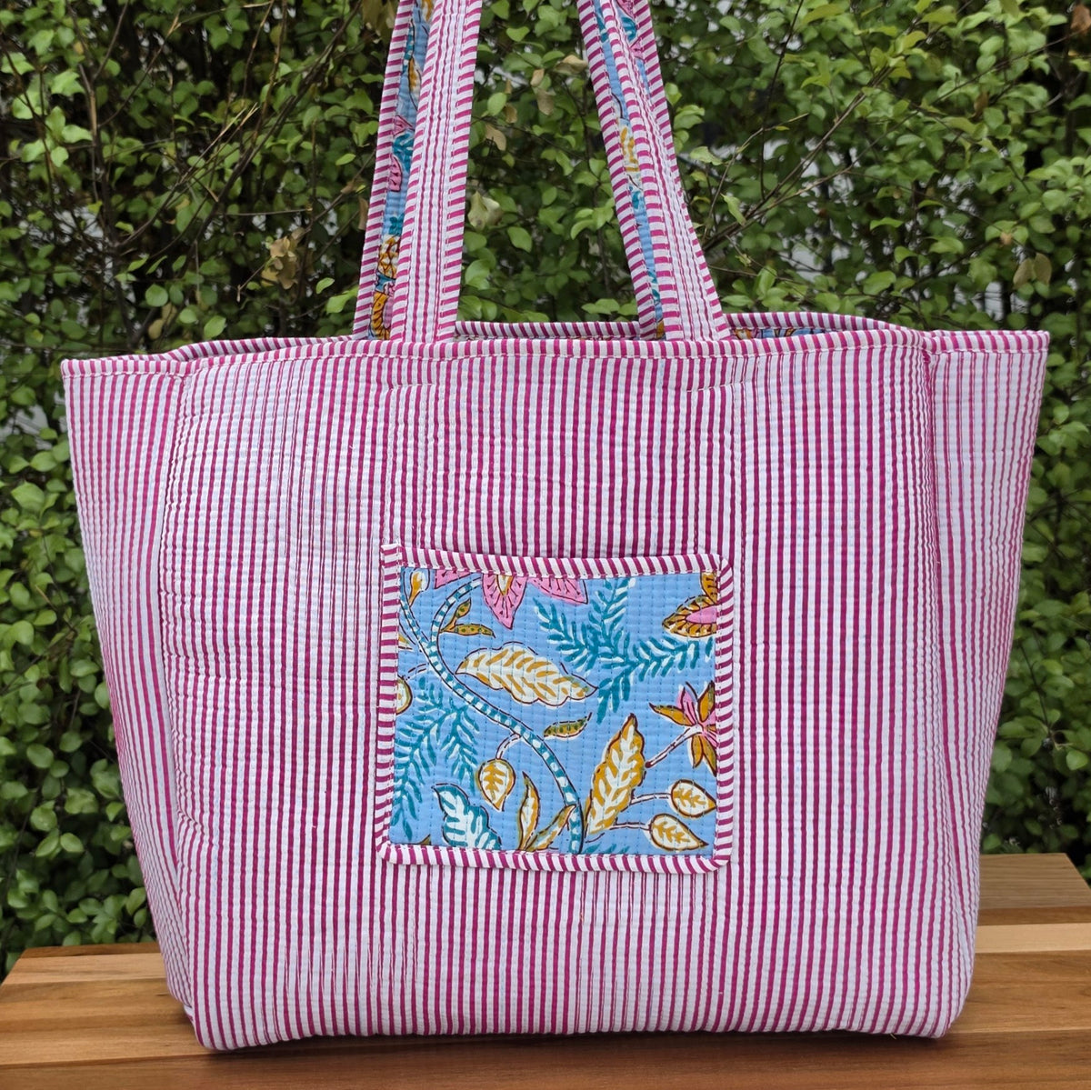 light blue floral and leaf pattern quilted cotton tote bag reversible machine washable with pockets lifestyle reverse image