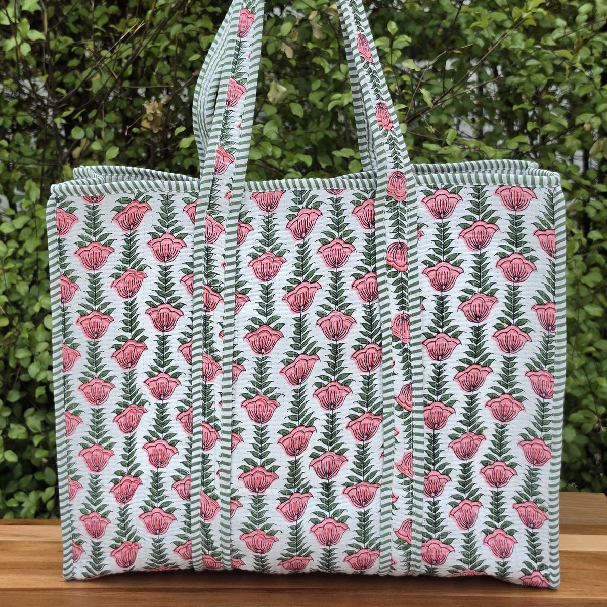 pink flowers in white background quilted cotton tote bag reversible machine washable with pockets lifestyle shot