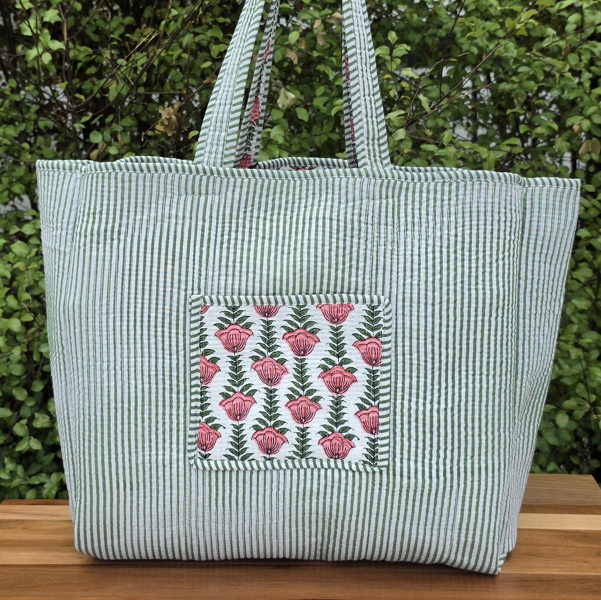 pink flowers in white background quilted cotton tote bag reversible machine washable with pockets reverse lifestyle shot
