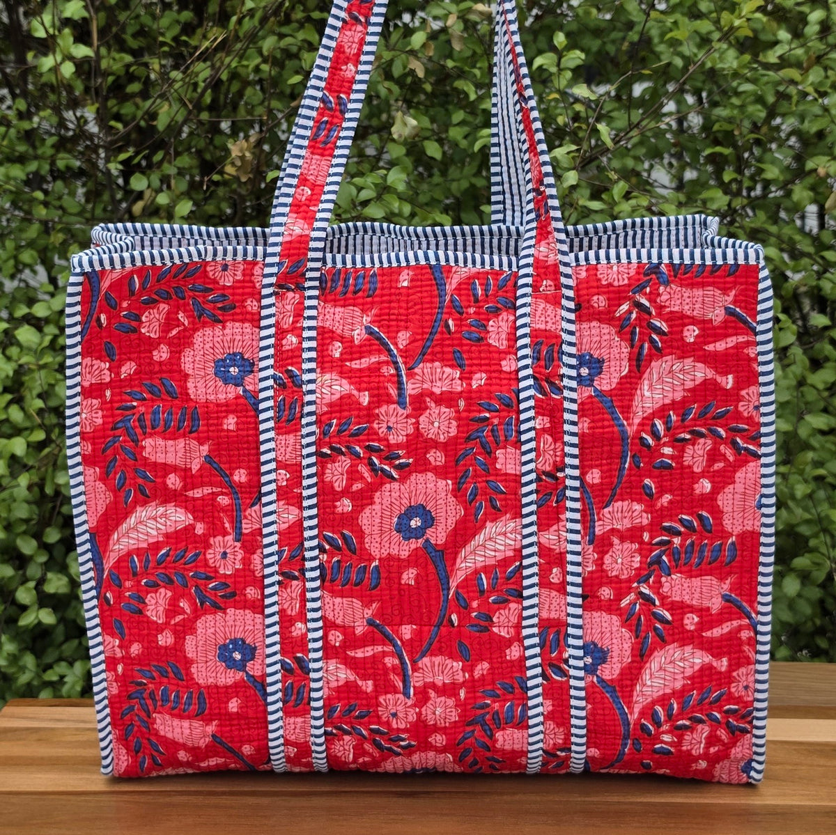 red and blue blockprint floral pattern quilted cotton tote bag reversible machine washable with pockets lifestyle image