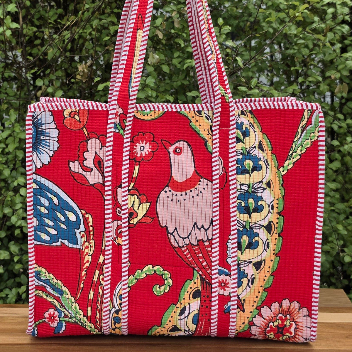 red vibrant bird print quilted cotton tote bag reversible machine washable with pockets lifestyle shot
