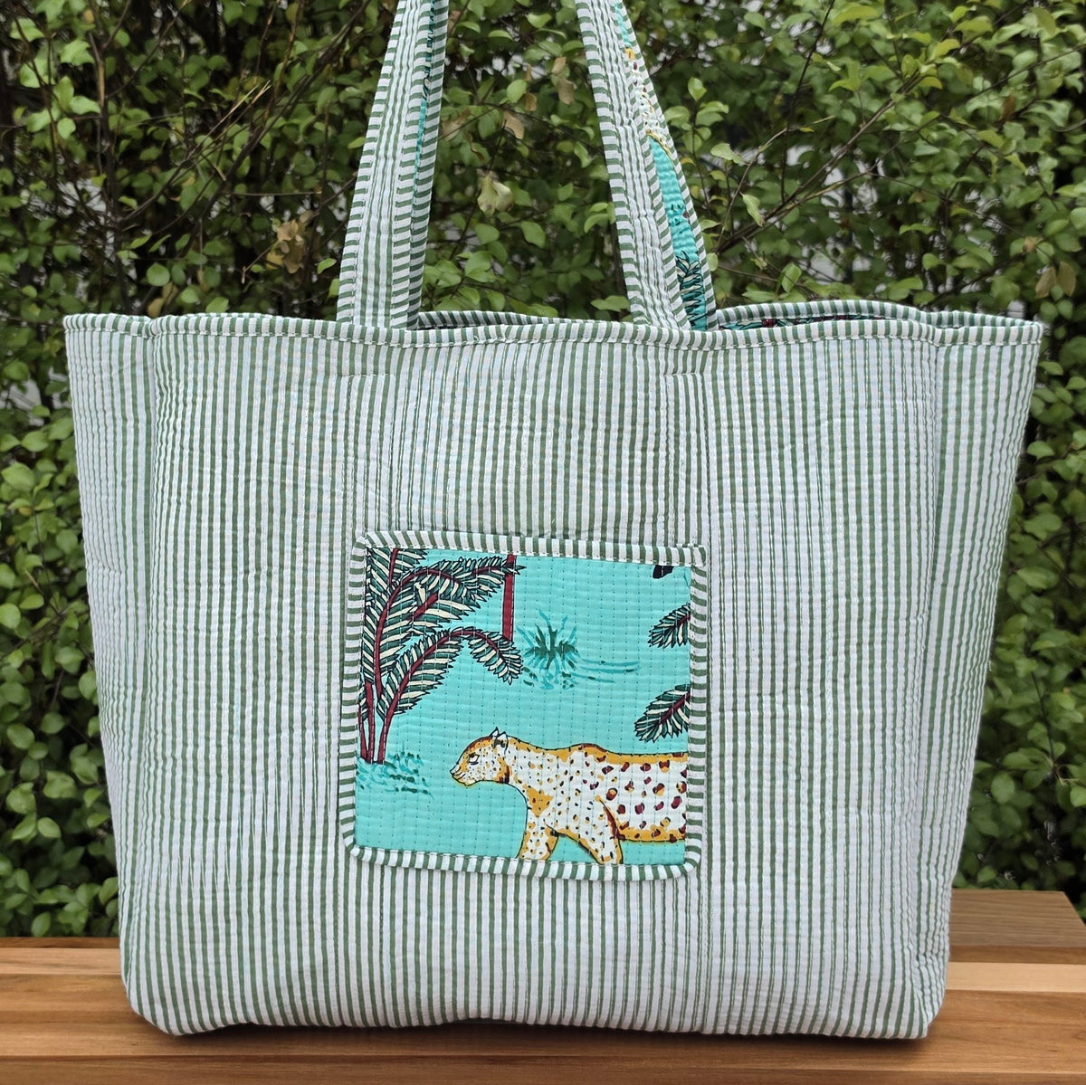 turqiose blue jungle print quilted cotton tote bag reversible machine washable with pockets reversible lifestyle shot