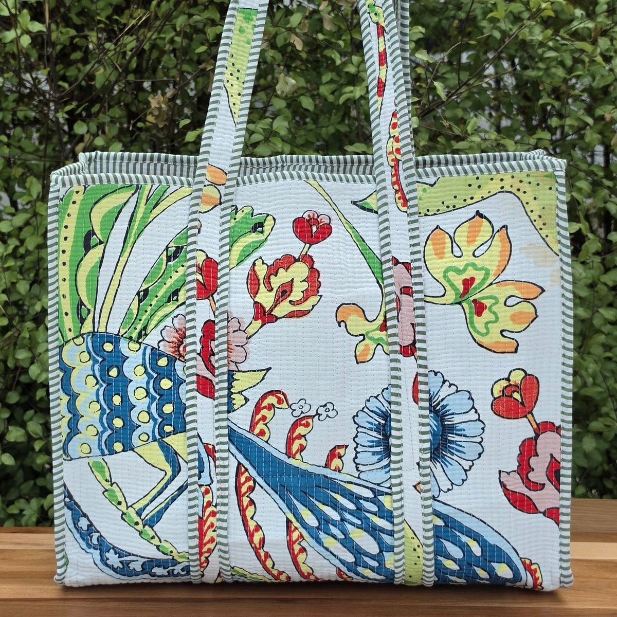 white vibrant bird print quilted cotton tote bag reversible machine washable with pockets lifestyle shot