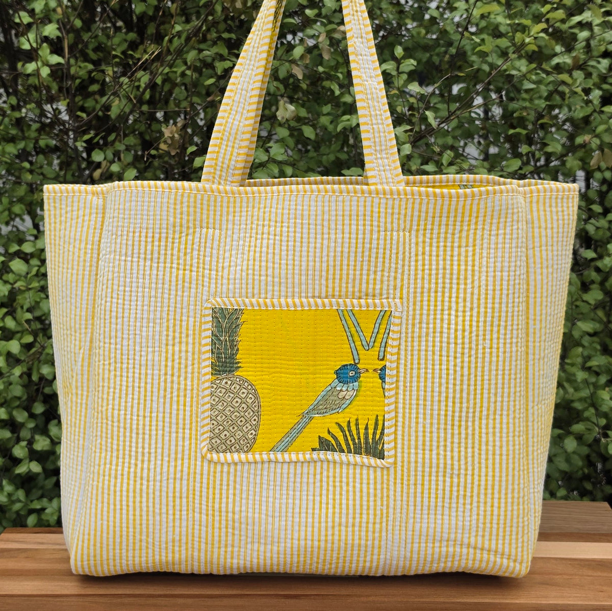 yellow and blue birds and fruits pattern quilted cotton tote bag reversible machine washable with pockets lifestyle reverse image